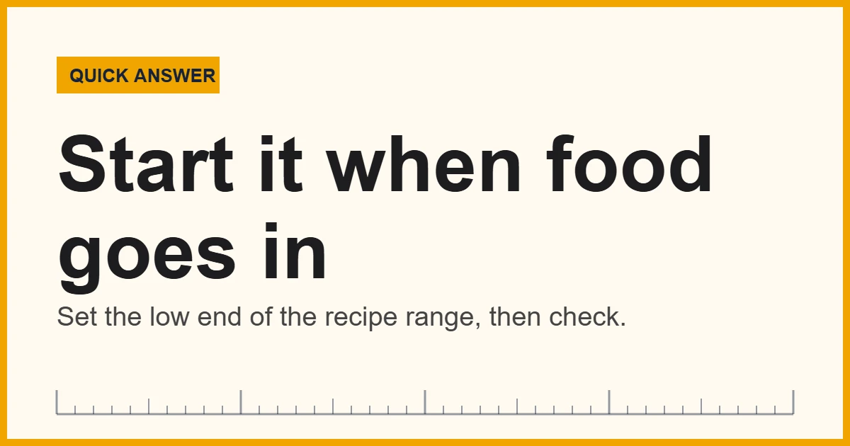 Kitchen timer set to 15 minutes on a counter next to a pot
