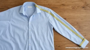 How to measure sleeve length on a dress shirt laid flat with a tailor tape